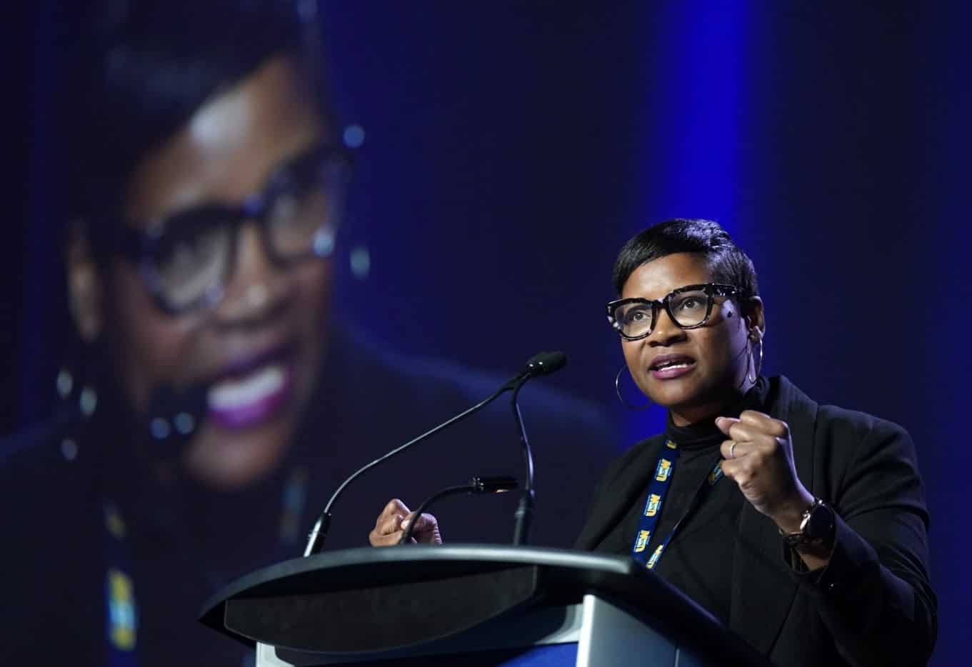 A woman standing behind a lectern