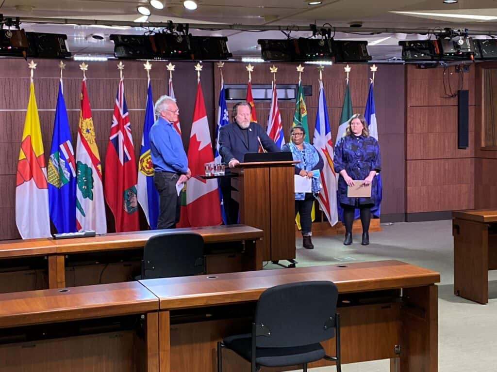 USW National Director Marty Warren speaking at a press conference on Parliament Hill announcing the launch of the joint USW/CLC complaint to the CORE, in presence of Kalpona Akter, Executive Director of BCWS, November 2022.
