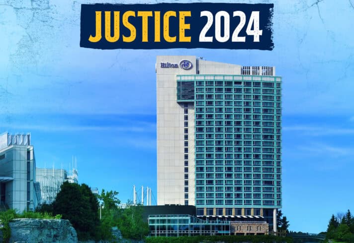 A photo of a Hilton hotel by a lake with the logo of the Justice conference 2024 at the very top.