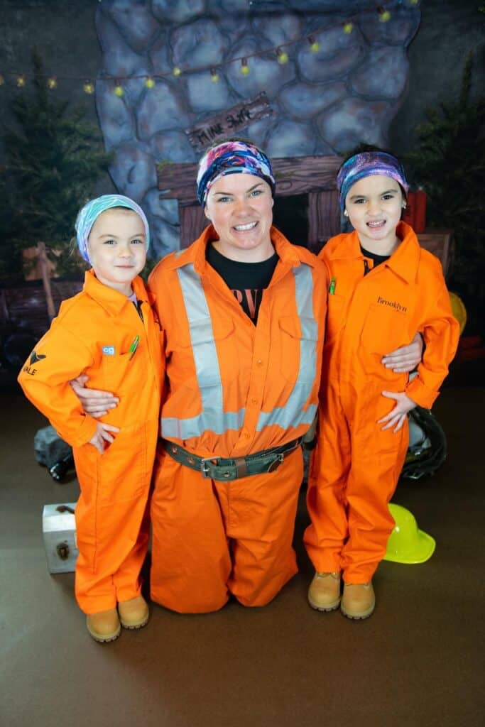 a mother and her 2 kids wearing orange jumpsuits