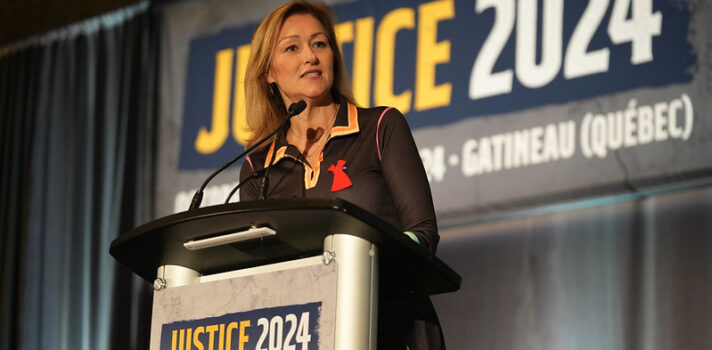 a person standing on the podium giving a speech 